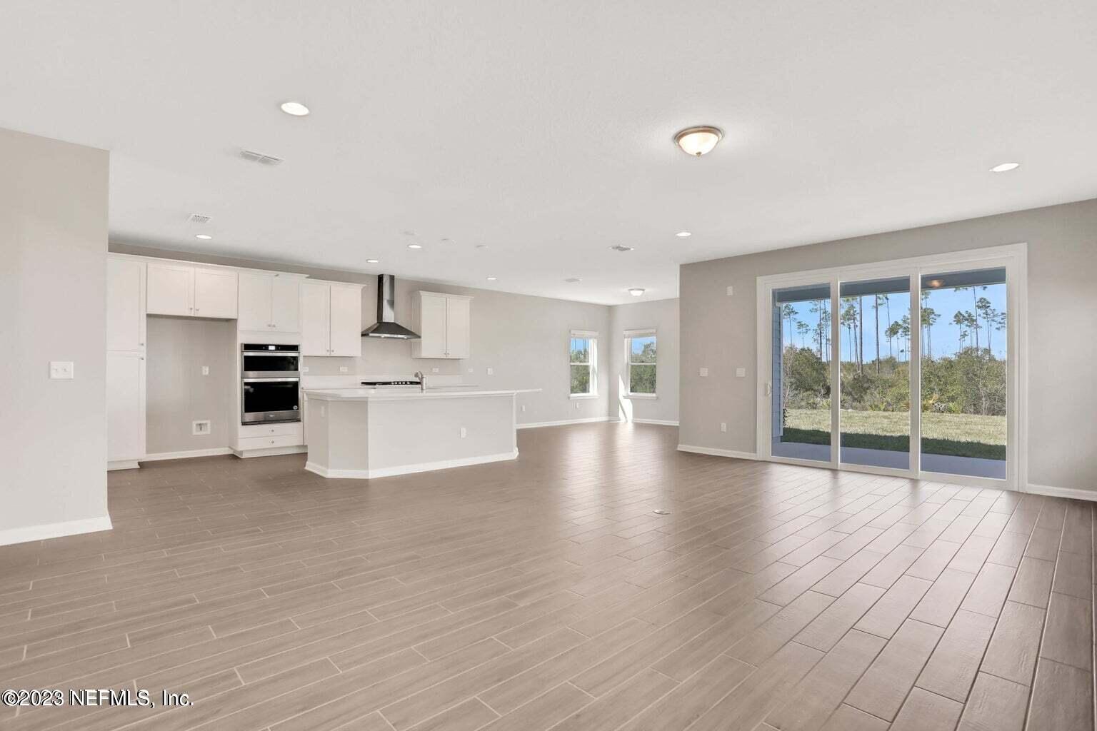 65 Torres Trace Street St. Augustine, FL 32095 - Photo 3 of 32 a view of kitchen with furniture and wooden floor