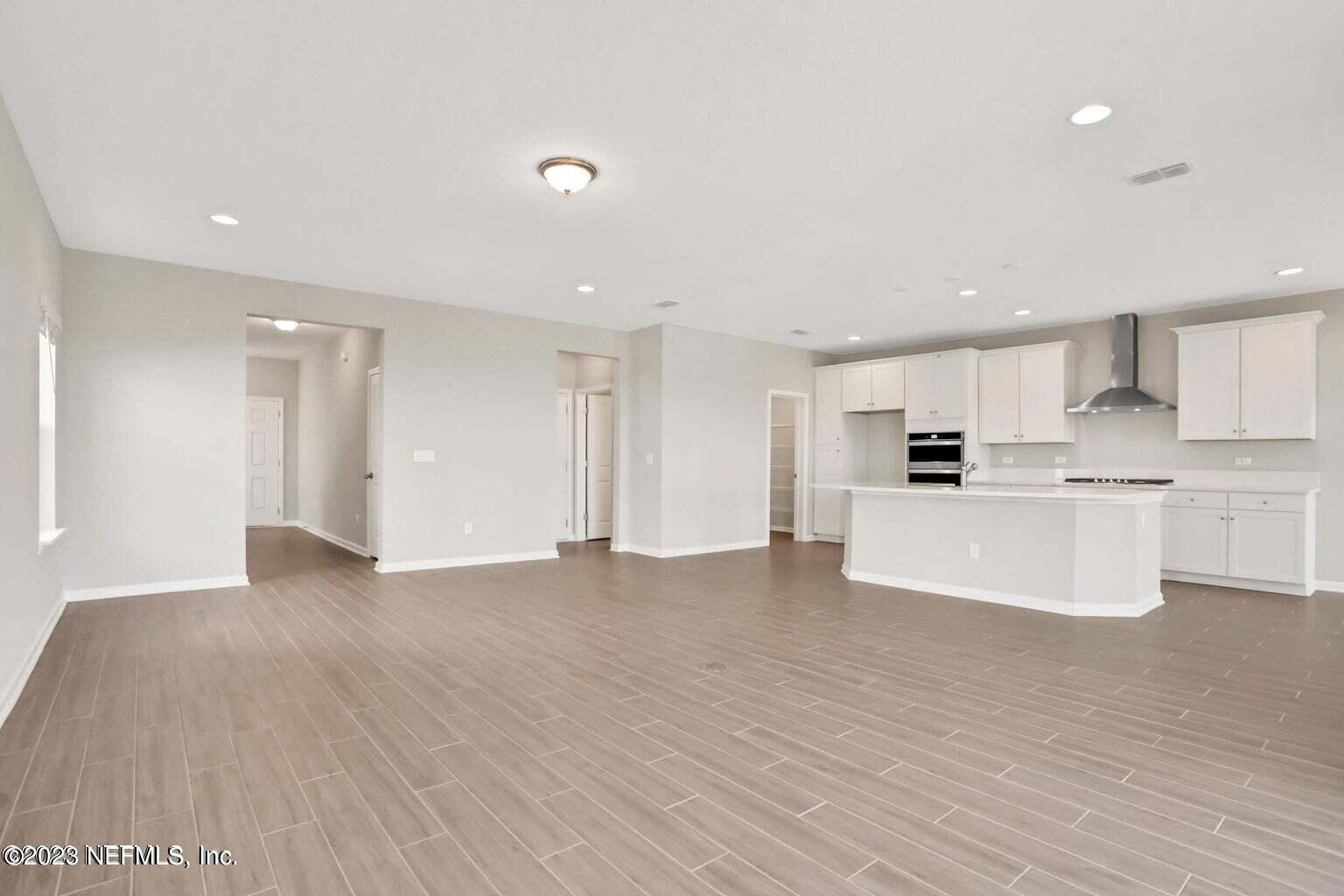 65 Torres Trace Street St. Augustine, FL 32095 - Photo 10 of 32 a view of kitchen with wooden floor and electronic appliances