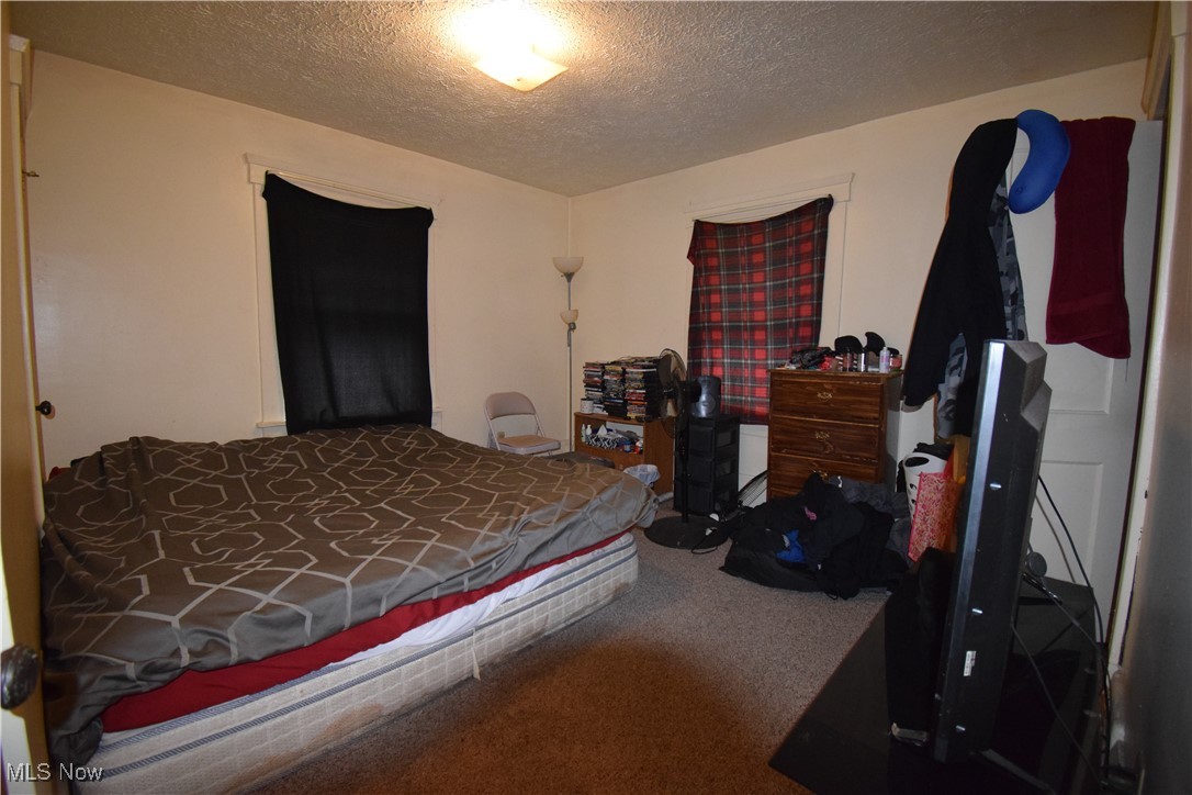 913 Lawrence Road Northeast Canton, OH 44704 - Photo 10 of 10 Carpeted bedroom featuring a textured ceiling