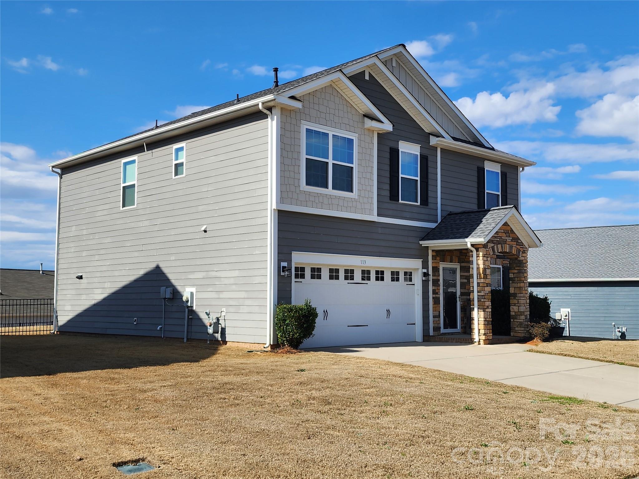113 East Neel Ranch Road Mooresville, NC 28115 - Photo 2 of 6 a front view of a house with a yard