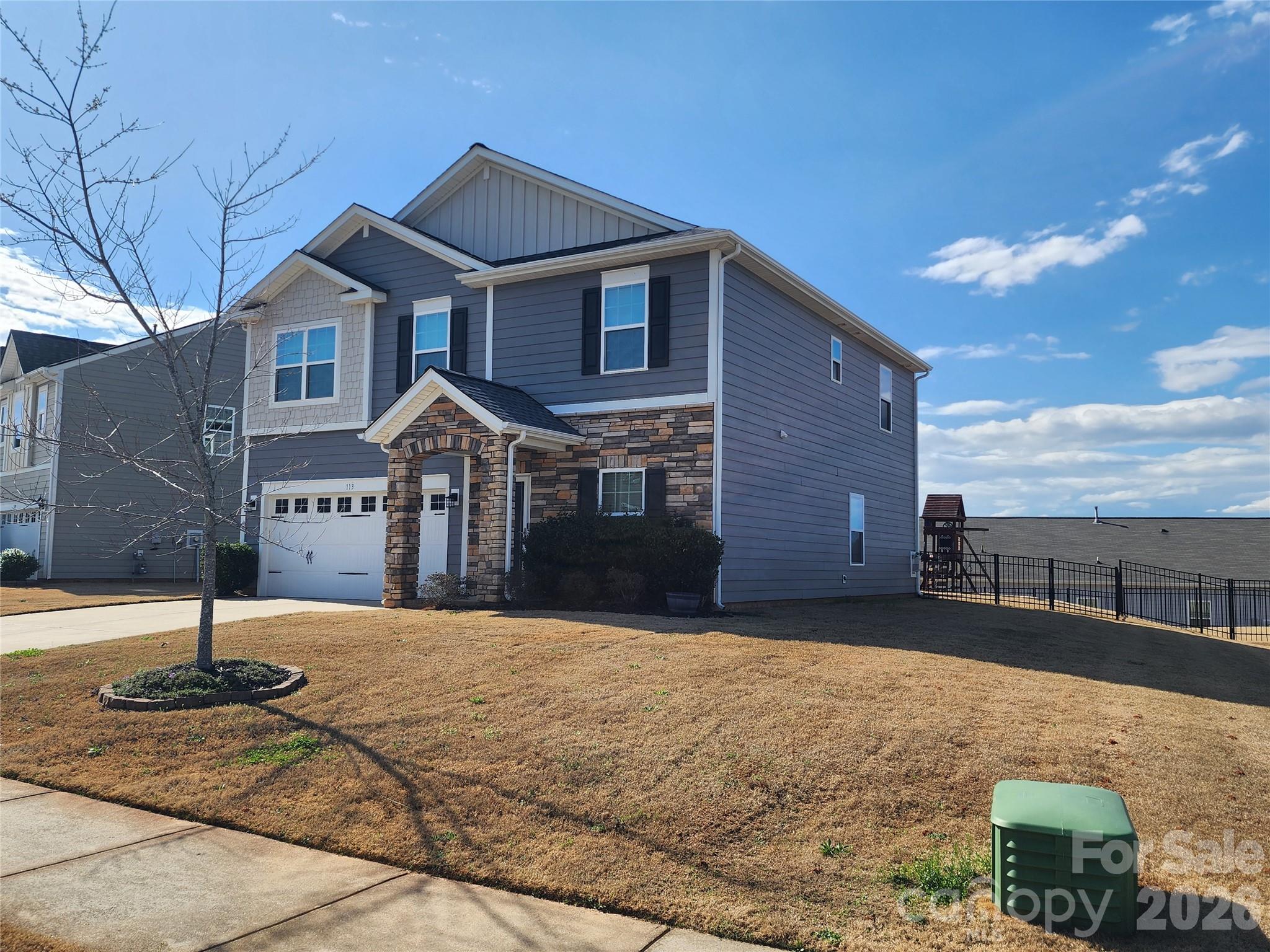 113 East Neel Ranch Road Mooresville, NC 28115 - Photo 3 of 6 a front view of a house with a yard