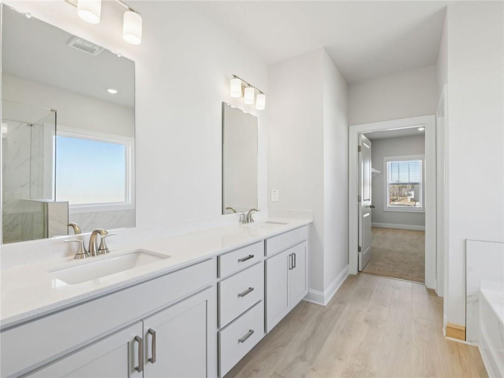 1291 Whitman Circle Monroe, GA 30656 - Photo 17 of 22 a bathroom with a double vanity sink and mirror