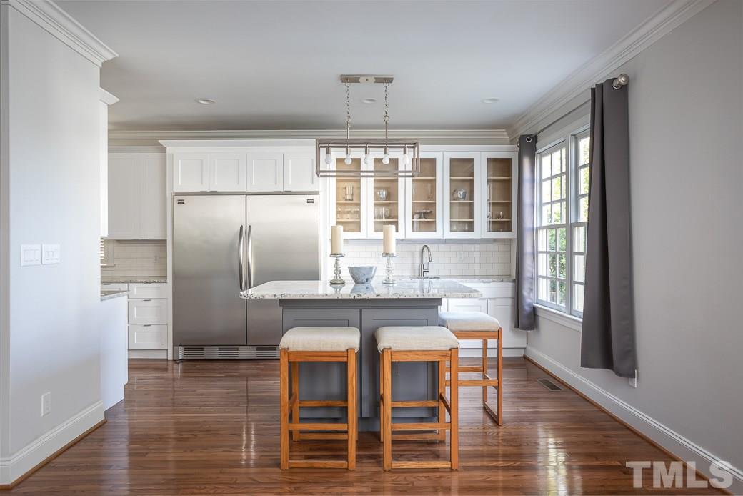 1305 Canfield Court Raleigh, NC 27608 - Photo 11 of 30 a table and chairs in a kitchen