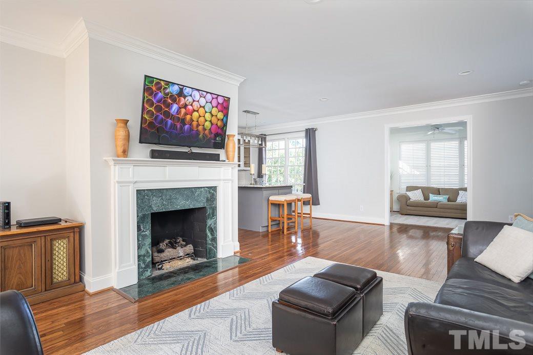 1305 Canfield Court Raleigh, NC 27608 - Photo 15 of 30 a living room with furniture and a fireplace