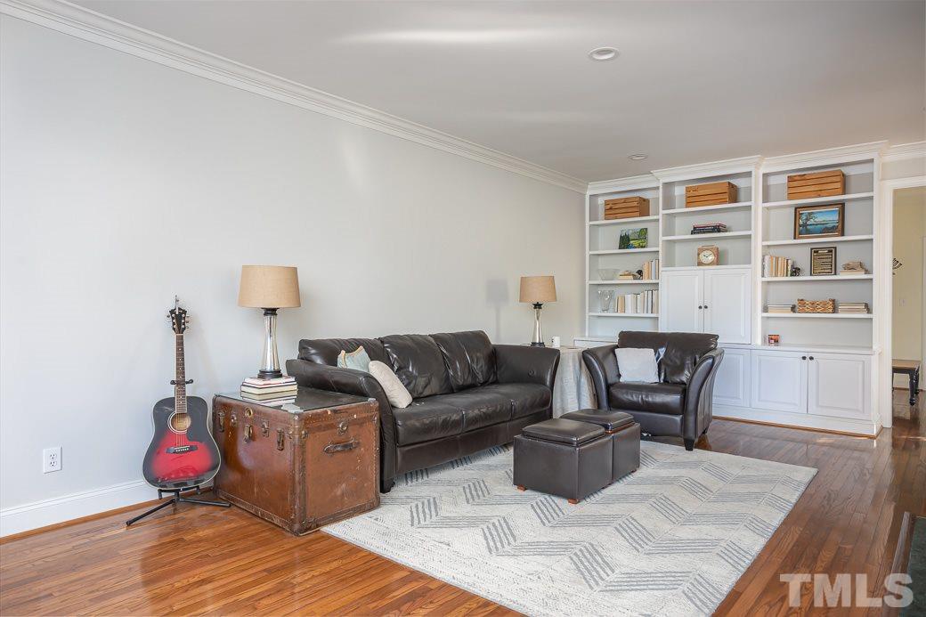 1305 Canfield Court Raleigh, NC 27608 - Photo 16 of 30 a living room with furniture a wooden floor and next to a window