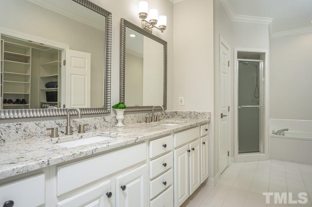 1305 Canfield Court Raleigh, NC 27608 - Photo 20 of 30 a bathroom with a granite countertop double vanity sink and a mirror
