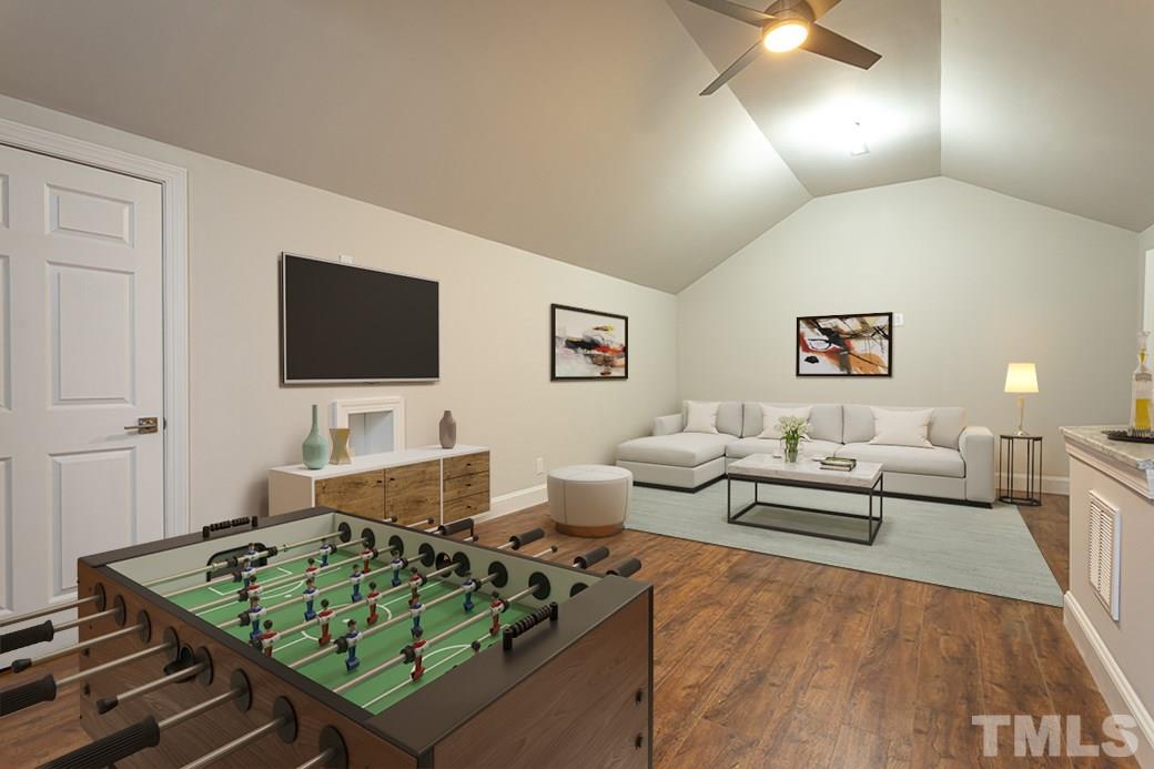 1305 Canfield Court Raleigh, NC 27608 - Photo 23 of 30 a living room with furniture and a flat screen tv
