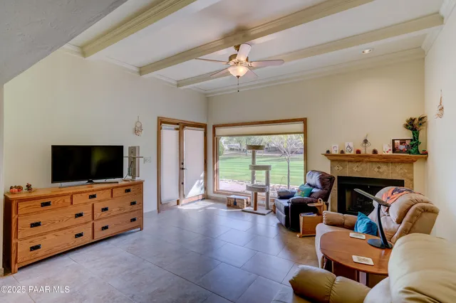a bedroom with a bed a dresser and a chandelier