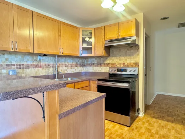 a view of a kitchen with a large window