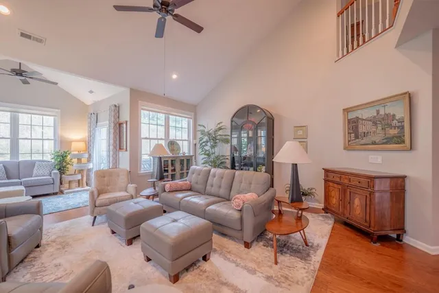 a living room with furniture and a wooden floor