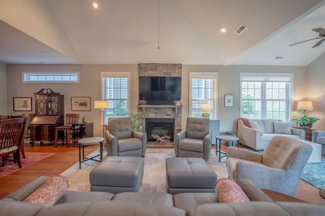 a living room with furniture fireplace and a flat screen tv
