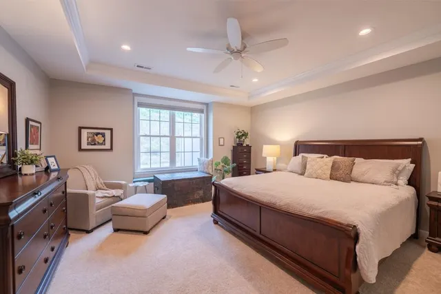 a spacious bedroom with a bed and a couch