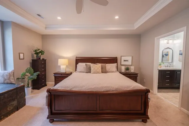 a bedroom with a bed and dresser with mirror