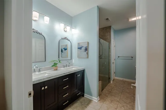 a spacious bathroom with a double vanity sink and a mirror