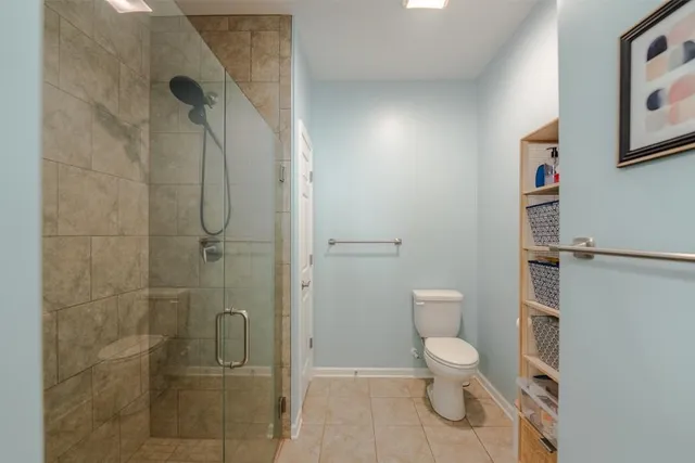 a bathroom with a toilet and a shower