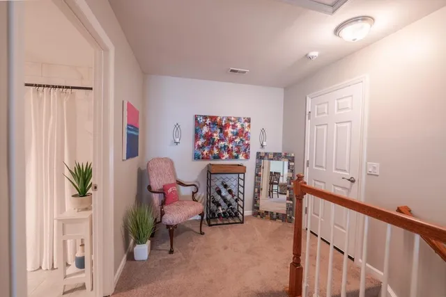 a view of a hallway with workspace and living room