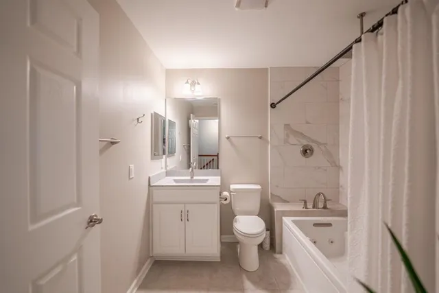 a bathroom with a toilet a sink and bathtub