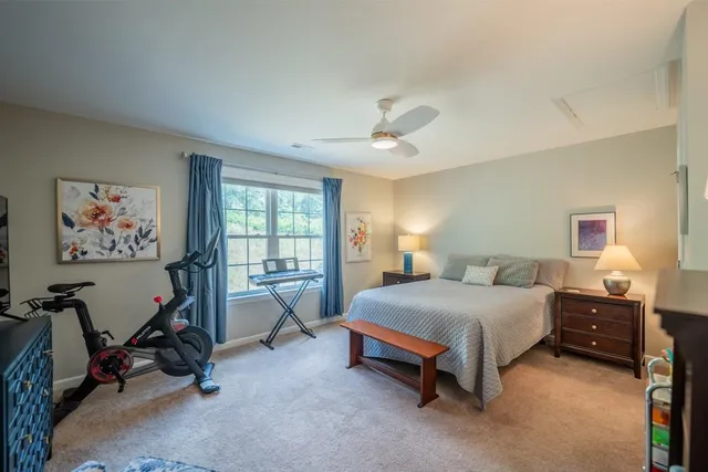 a bedroom with a bed a desk and chair