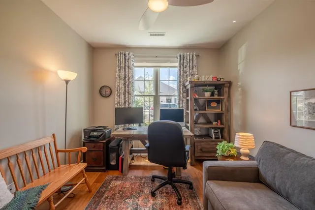 a view of a livingroom with workspace and a window