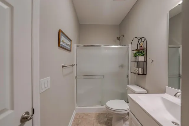 a bathroom with a toilet and a shower
