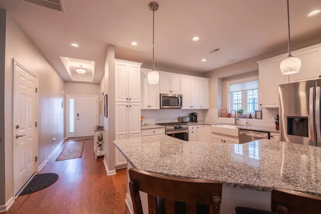 a kitchen with stainless steel appliances granite countertop a stove refrigerator and oven