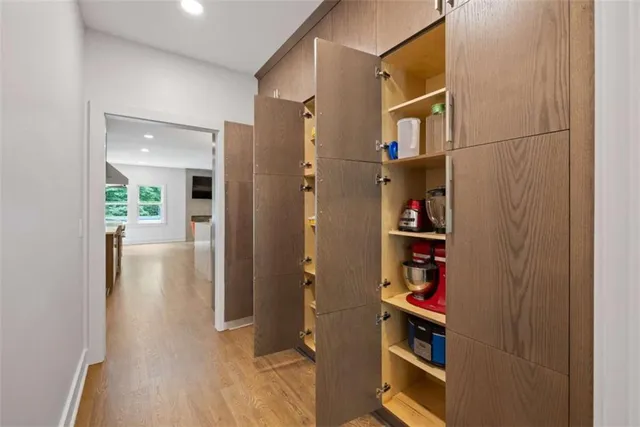 a view of entryway and hall with wooden floor