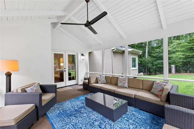 a spacious bedroom with a bed and a chair