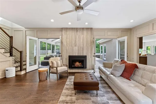 a living room with furniture and a wooden floor