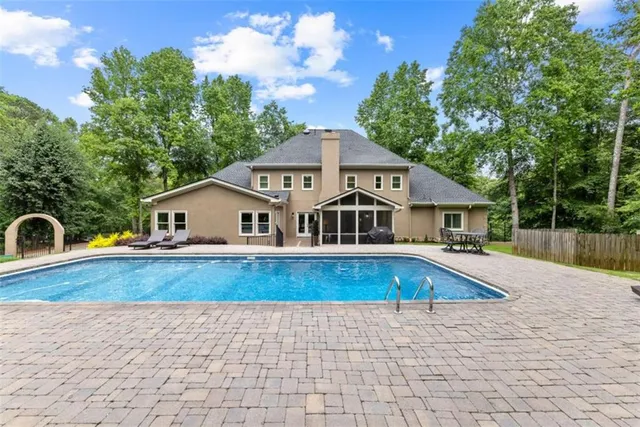 a kitchen with stainless steel appliances kitchen island granite countertop a sink a stove and a wooden floors
