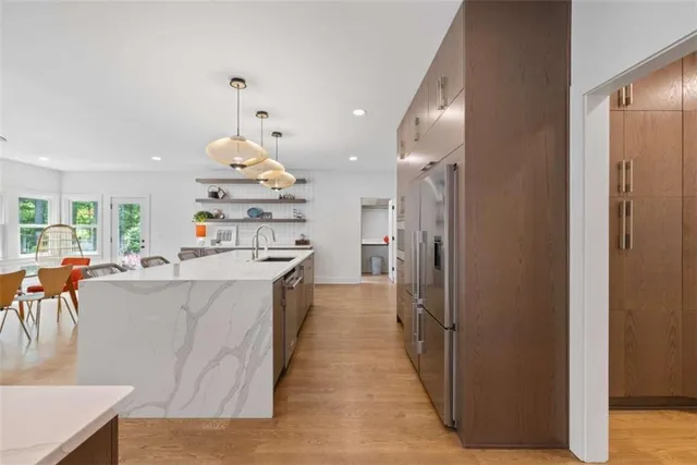 a view of a hallway with wooden floor and closet
