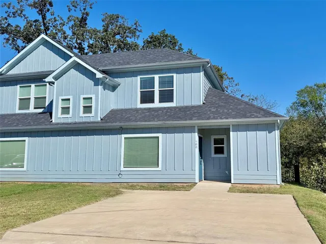 a house that has a large window in front of it