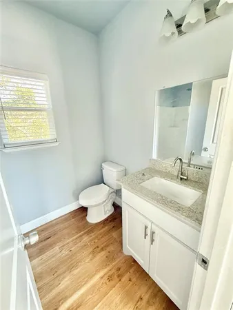 a spacious bathroom with a granite countertop sink and a mirror