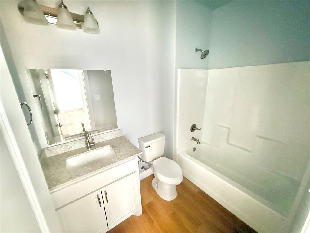 986 South 6th Avenue, Unit 988 Denison, TX 75021 - Photo 7 of 15 a bathroom with a sink a toilet and shower