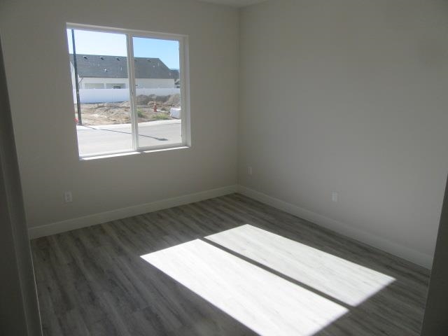 2468 Revere Road Grand Junction, CO 81505 - Photo 16 of 26 an empty room with wooden floor and windows