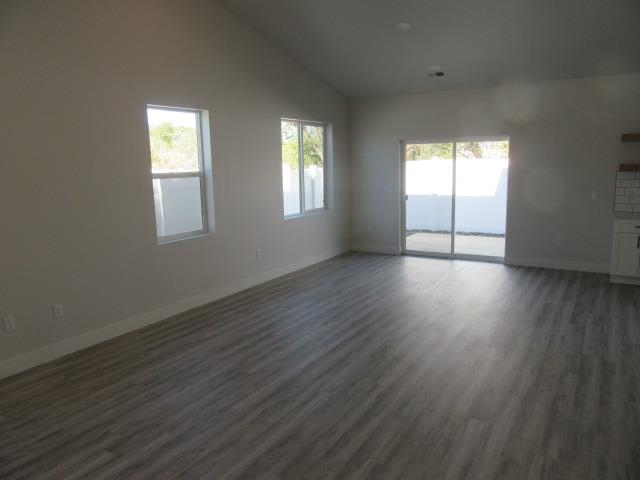 2468 Revere Road Grand Junction, CO 81505 - Photo 6 of 26 a view of an empty room with wooden floor and a window