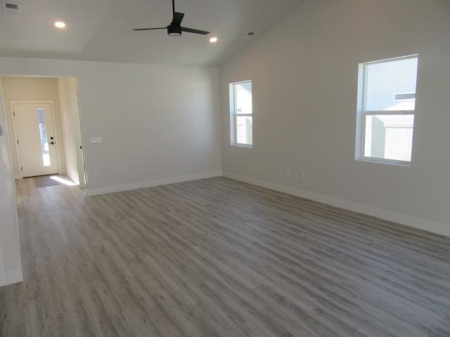 2468 Revere Road Grand Junction, CO 81505 - Photo 7 of 26 an empty room with wooden floor and windows