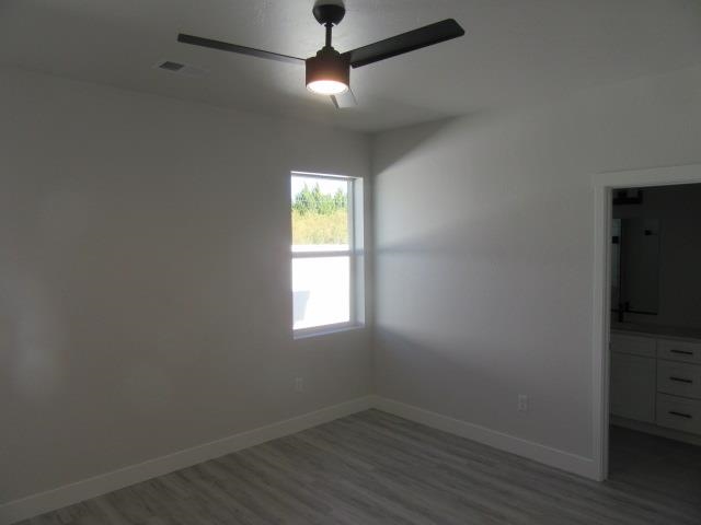 2468 Revere Road Grand Junction, CO 81505 - Photo 8 of 26 an empty room with a window and wooden floor