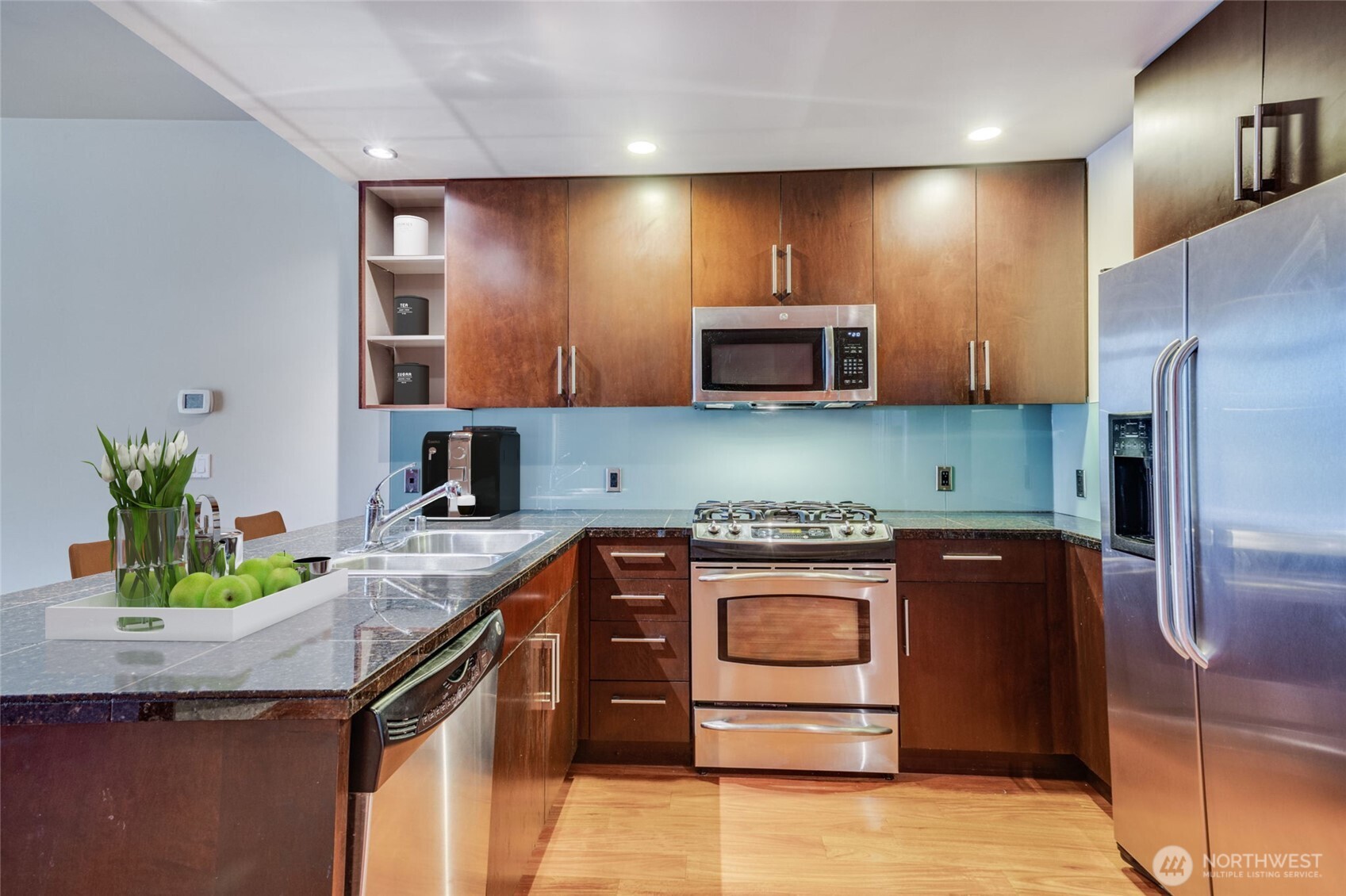 900 Lenora Street, Unit W803 Seattle, WA 98121 - Photo 7 of 29 a kitchen with stainless steel appliances granite countertop a stove a sink and a refrigerator