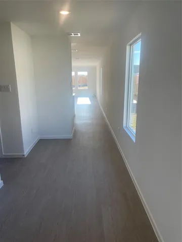 en empty room with windows and entrance