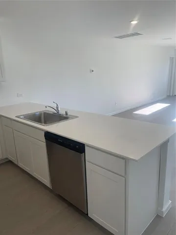 a kitchen with a sink and cabinets