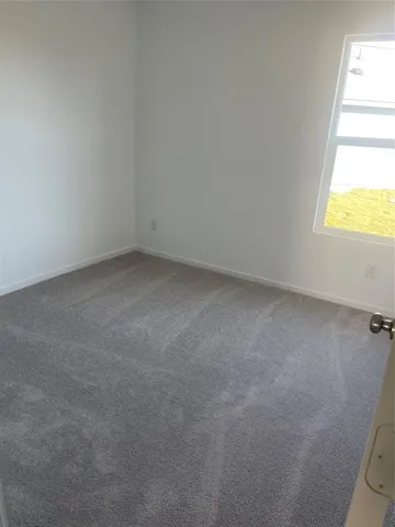 a view of an empty room and a window