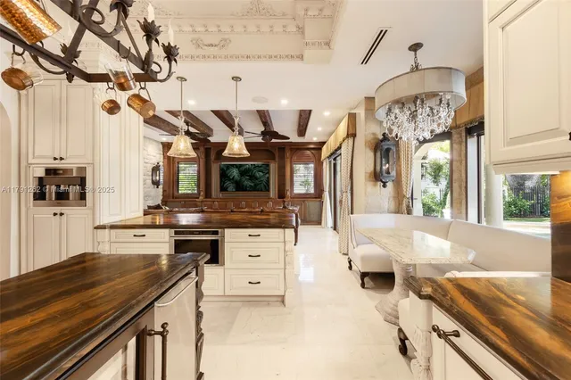 a living room with furniture and chandelier