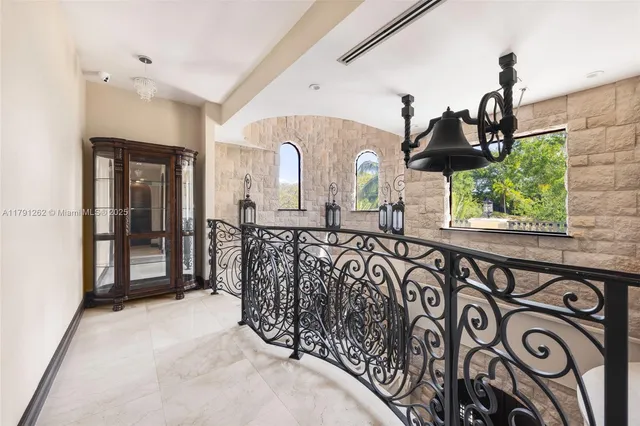 a view of a hallway with a car parked in garage