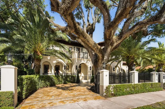 a front view of a house with yard and green space