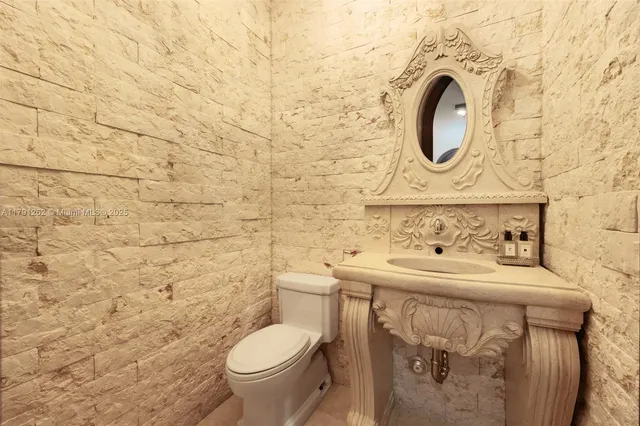 a bathroom with a sink a toilet and a mirror