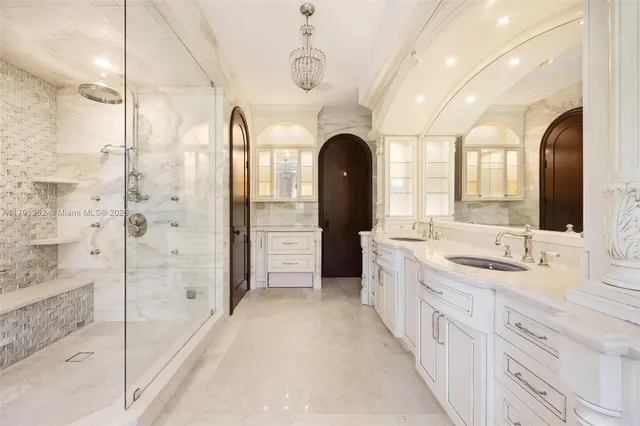 a spacious bathroom with a double vanity sink a large mirror a shower and bathtub