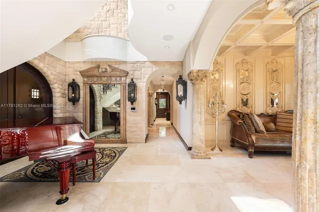 a view of a livingroom with furniture and a hallway