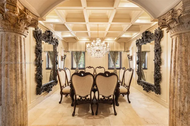 a view of a dining room with furniture and a chandelier
