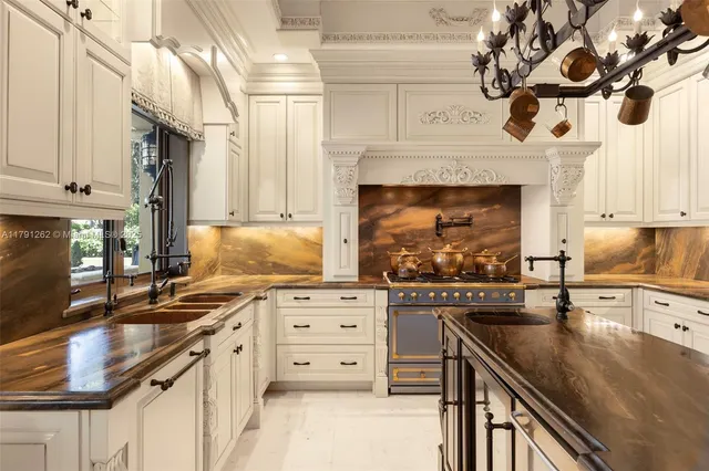 a kitchen with stainless steel appliances granite countertop a stove and a sink