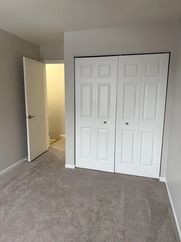 a bathroom with a granite countertop toilet and a sink